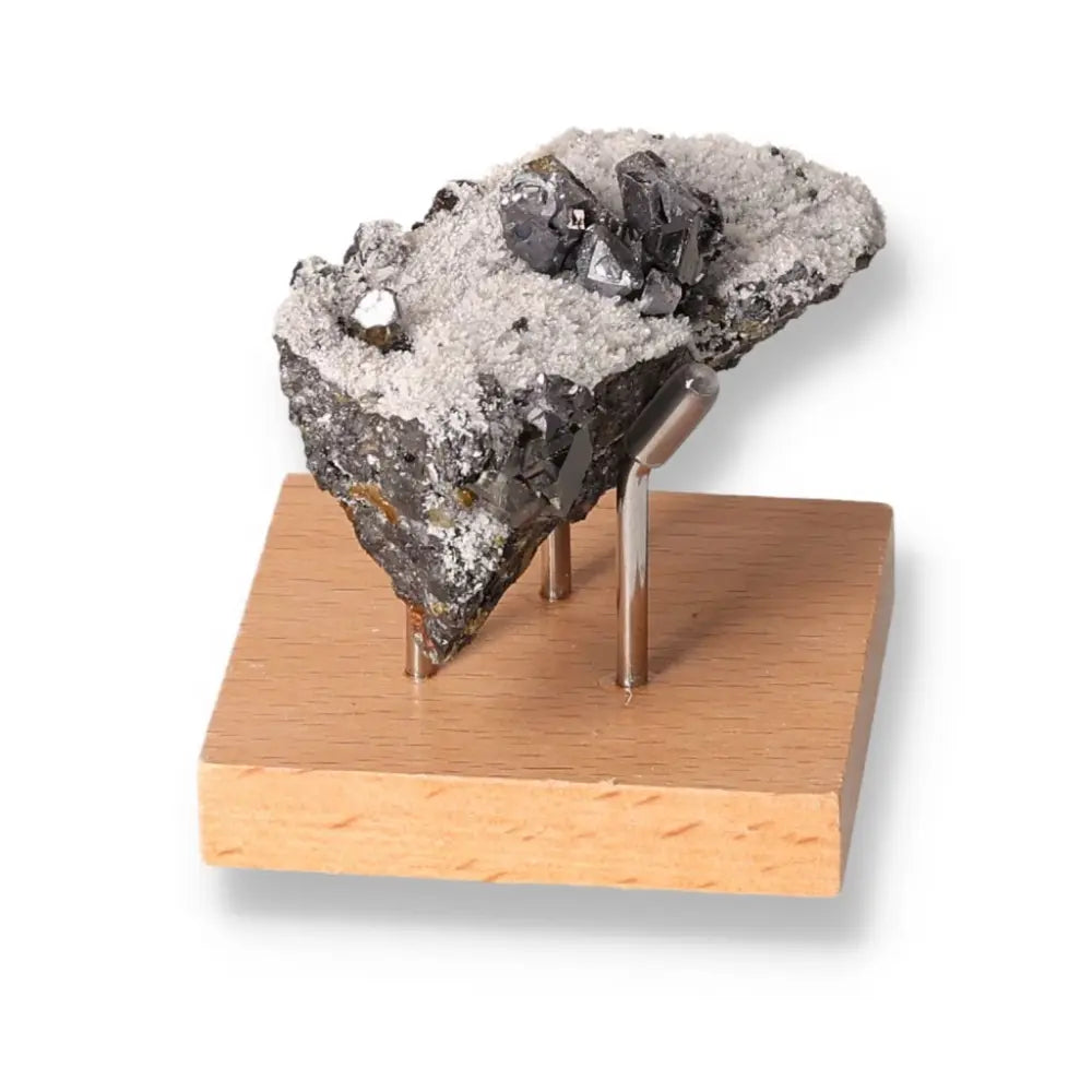 Galena stone on display stand, known for its grounding and protective properties, used in spiritual practices for transformation and harmony.