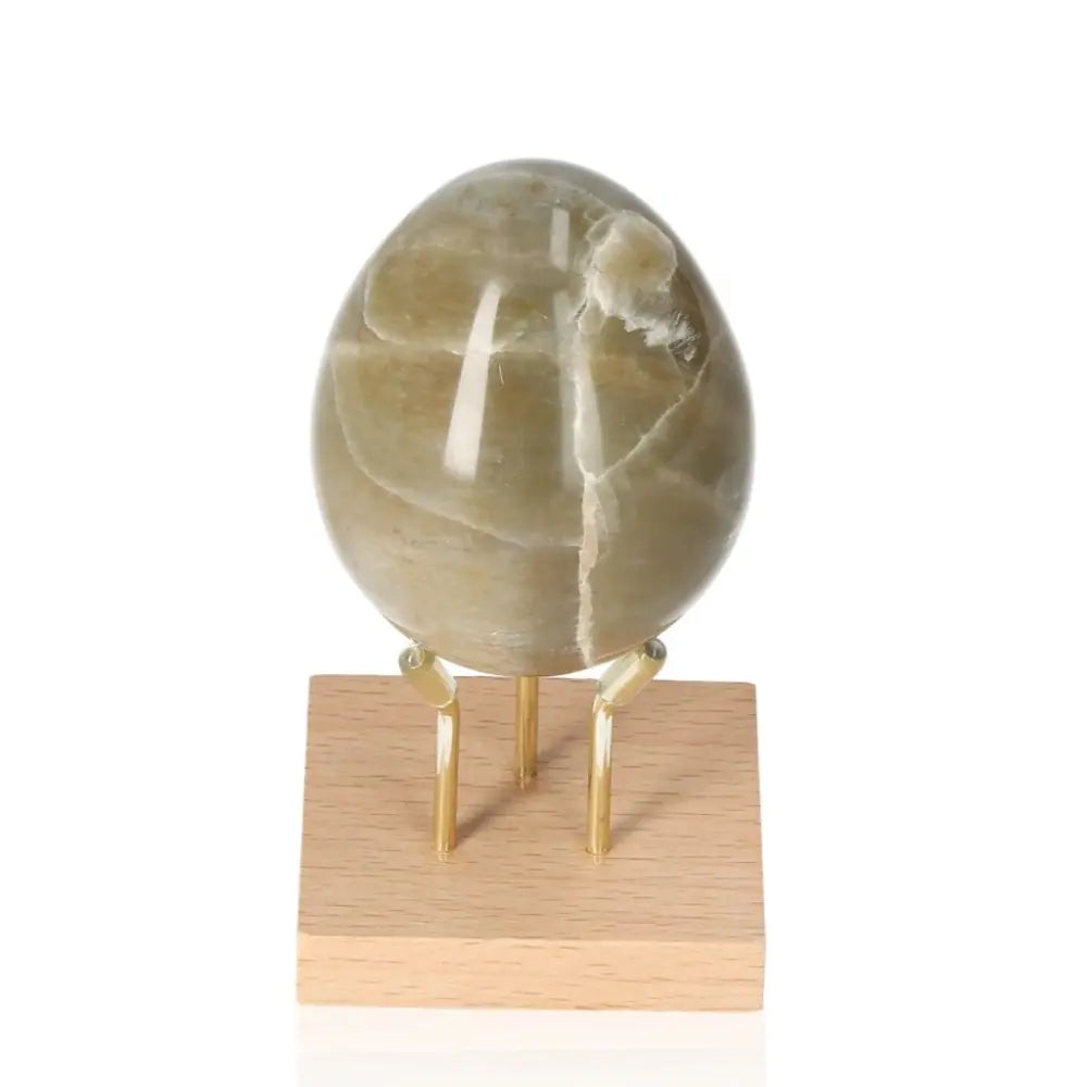 Garnierite Egg on stand symbolizing prosperity and heart-centered healing, activates Heart Chakra for emotional balance and abundance.