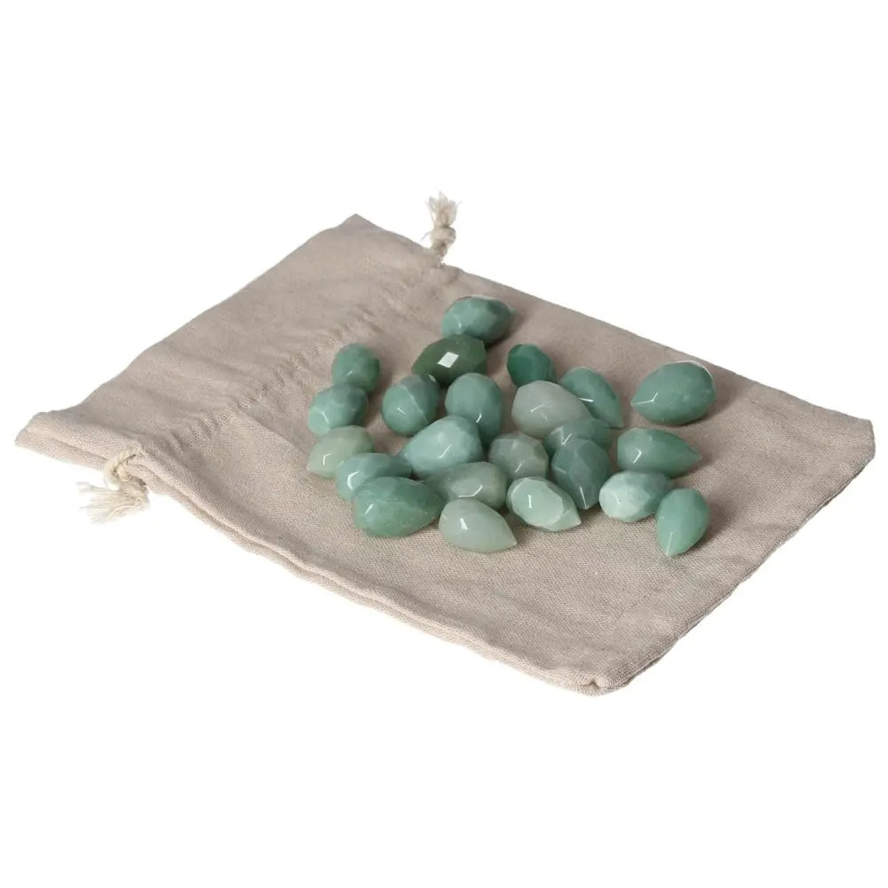 Green Aventurine small tear stones on beige pouch, symbolizing new beginnings and prosperity, ideal for attracting luck and inner peace.
