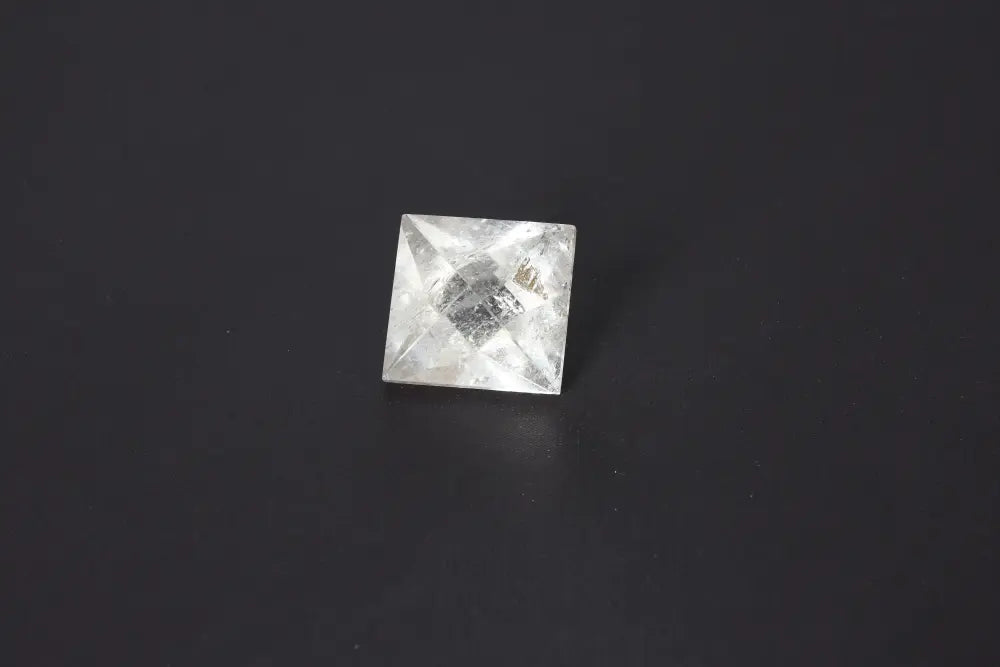 Lemurian Quartz Double Pyramid 3.5 cm, showcasing sacred geometry with spiritual significance, on a dark background.