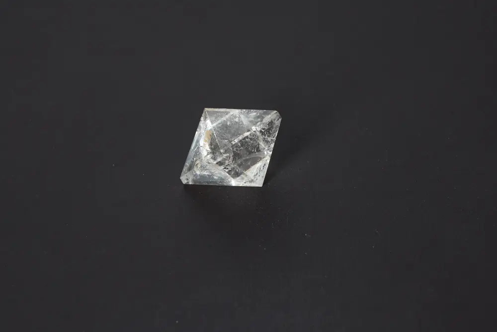 Lemurian Quartz Double Pyramid 3.5 cm showcasing sacred geometry on a dark background, known for awakening intuition and inner truth.