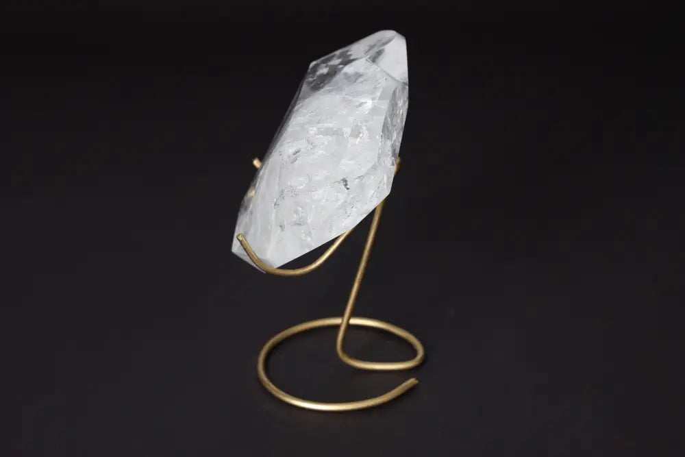 Elegant Lemurian Quartz Geometric Heart displayed on a gold stand, showcasing its clarity and unique geometry.