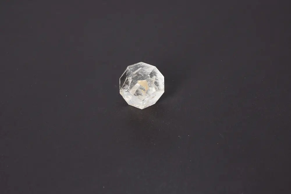 Lemurian Quartz geometric sphere on dark background, showcasing its clarity and sacred geometry for spiritual connection and ancient wisdom.