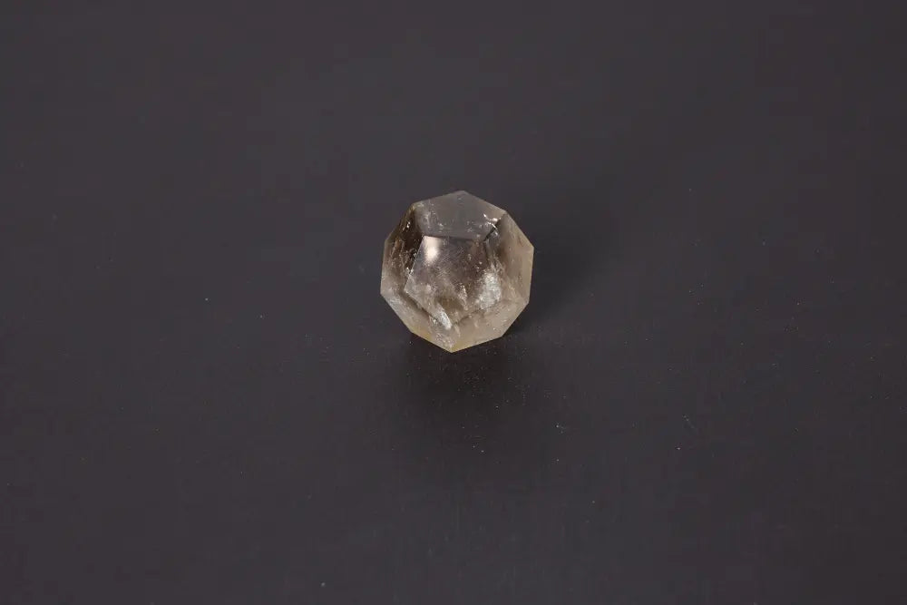 Lemurian Quartz Geometric Sphere with sacred geometry, showcasing natural clarity and horizontal striations, 4 cm size on a dark background.