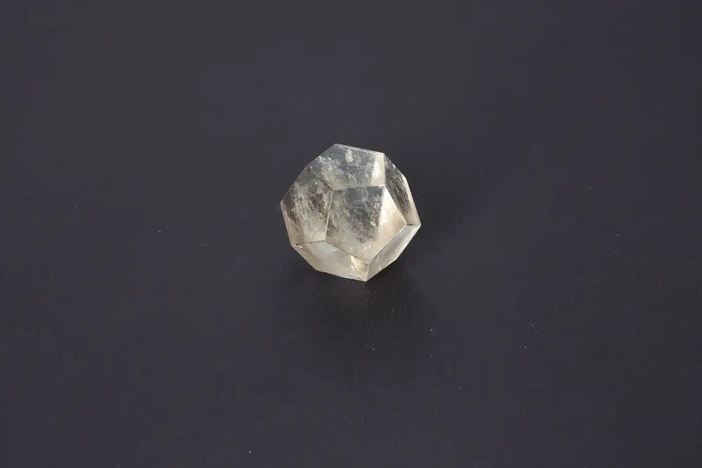 Lemurian Quartz Geometric Sphere 4.5 cm on dark background showcasing sacred geometry and ancient wisdom attributes.
