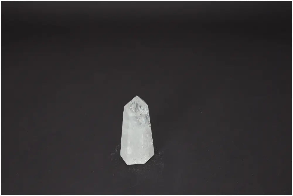 Lemurian Quartz Obelisk crystal on dark background, known for its unique energetic properties and chakra alignment.