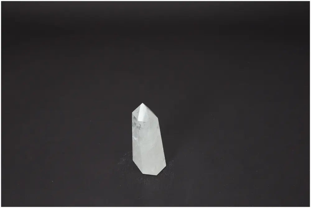 Lemurian Quartz Obelisk on dark background, showcasing unique properties for energetic and spiritual needs. Ideal for chakras and zodiac support.