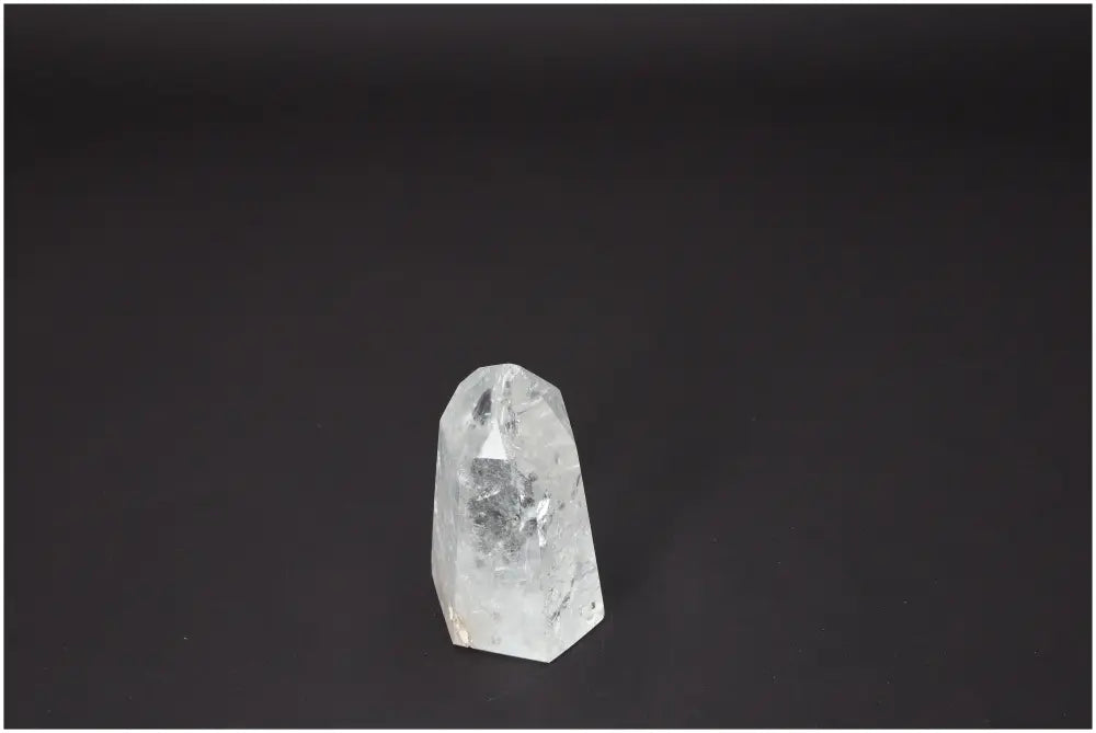Lemurian Quartz Obelisk crystal with spiritual and energetic properties on a dark background, supporting chakra and zodiac alignment.