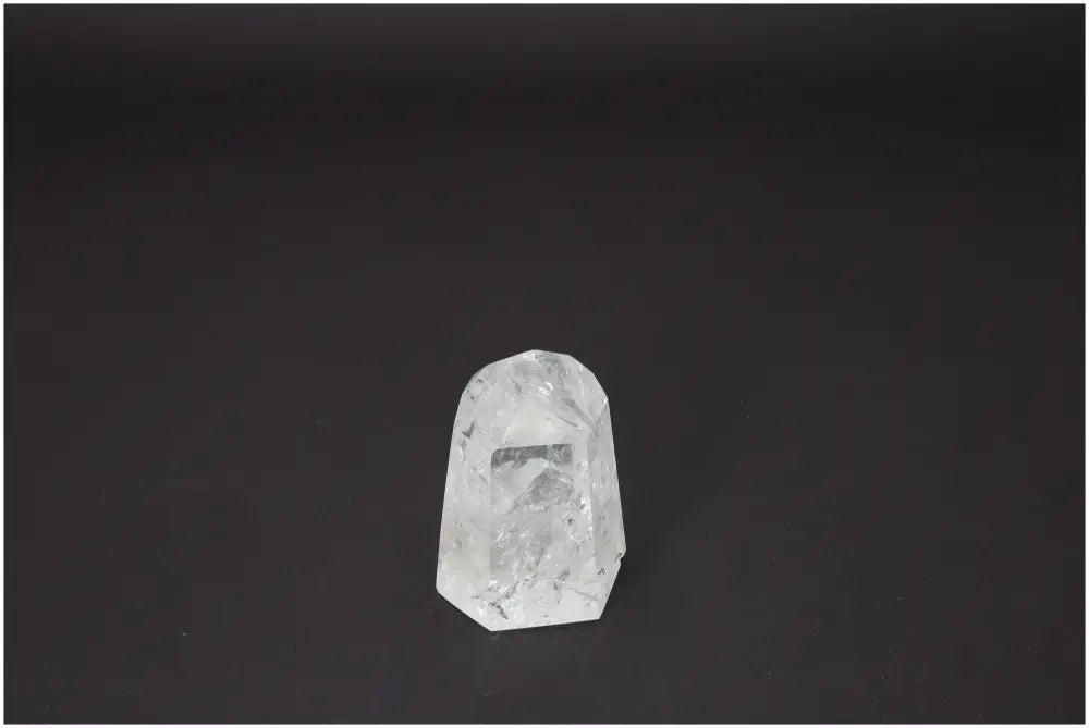 Lemurian Quartz Obelisk against black background, showcasing its clear crystal structure and spiritual energy properties.