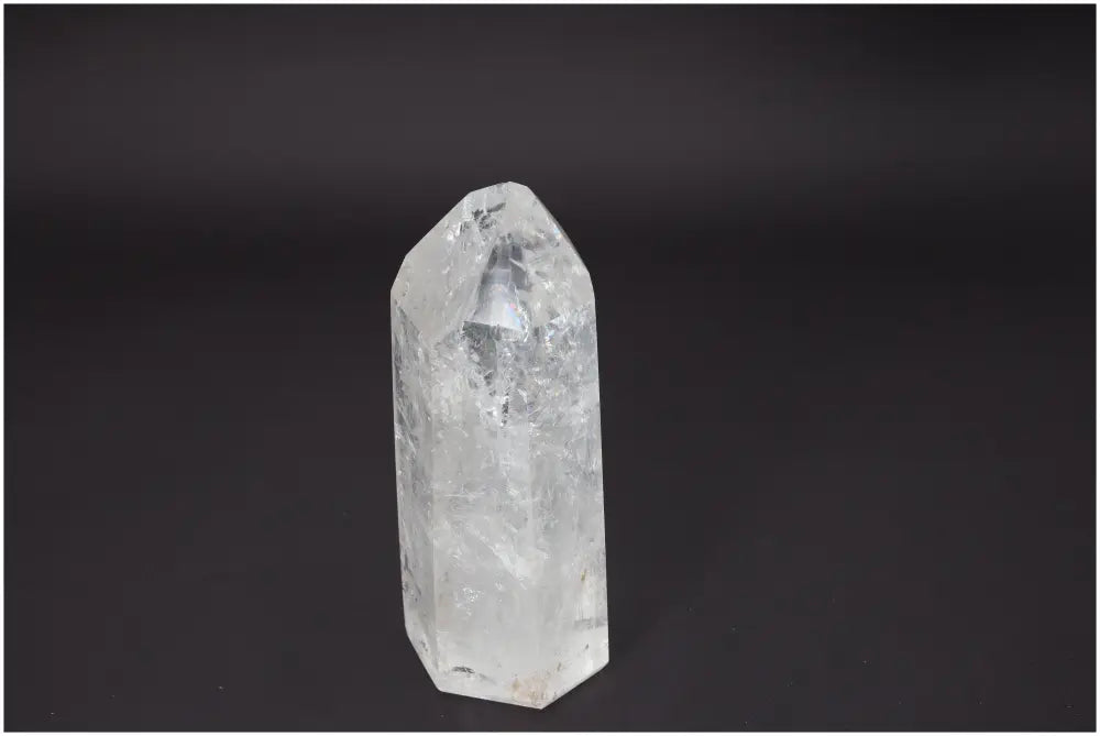 Lemurian Quartz Obelisk, clear and faceted, associated with energy healing and balance in chakras and zodiac signs.