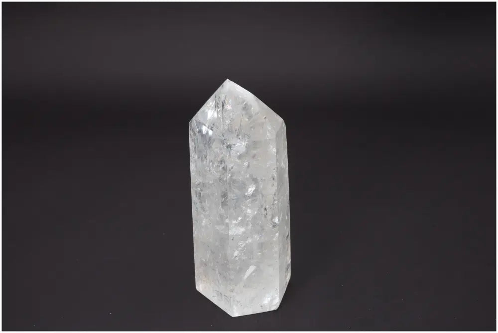 Lemurian Quartz Obelisk for chakra balance and spiritual energy, featuring radiant crystal structure against dark background