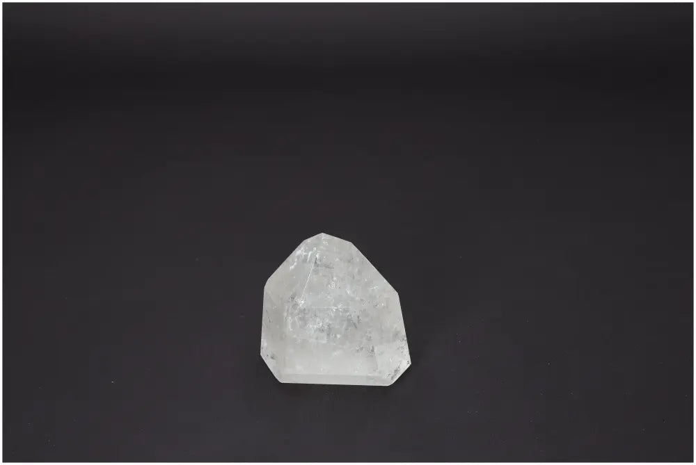 Clear Lemurian Quartz Obelisk on dark background showcasing its unique properties for chakra and spiritual enhancement.