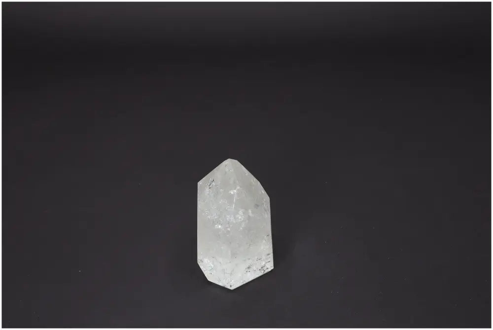 Lemurian Quartz Obelisk for chakra alignment and zodiac harmony on dark background; enhances body and soul with unique properties.