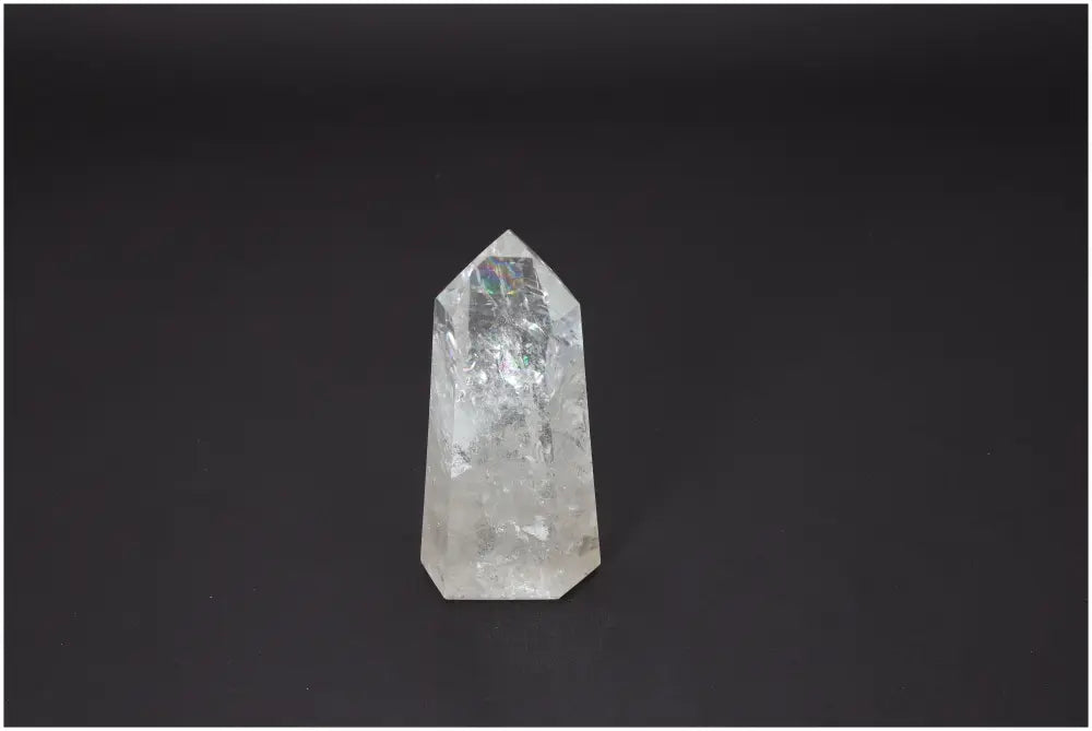 Lemurian Quartz Obelisk on dark background, a crystal known for chakra alignment and spiritual balance.