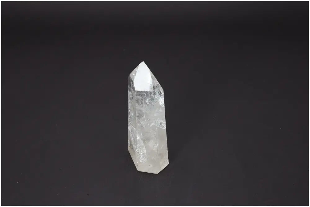 Lemurian Quartz Obelisk on black background, associated with chakras and zodiac signs, enhancing spiritual and energetic properties.