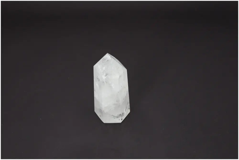 Lemurian Quartz Obelisk against black background, highlighting its natural clarity and spiritual properties for chakra and zodiac energy alignment.