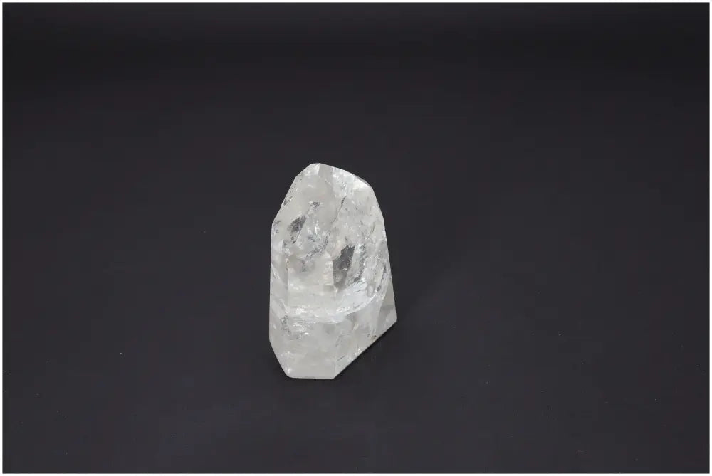 Lemurian Quartz Obelisk on black background, reflecting spiritual and energetic properties with chakra and zodiac associations.