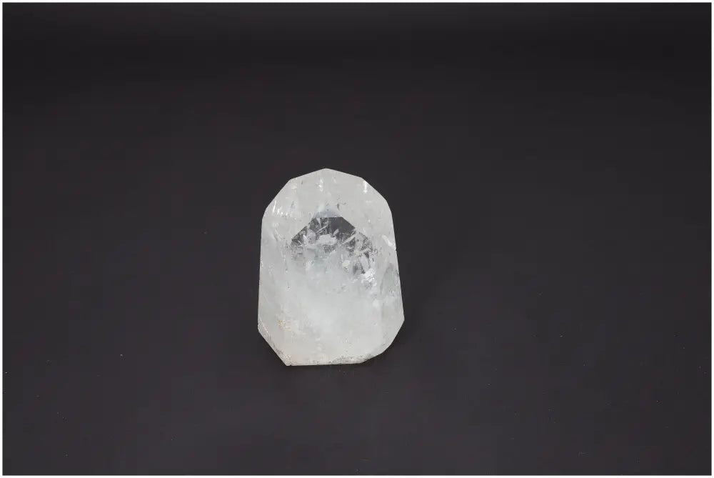Lemurian Quartz Obelisk on dark background displaying natural clarity and spiritual properties for chakras and zodiac alignment.
