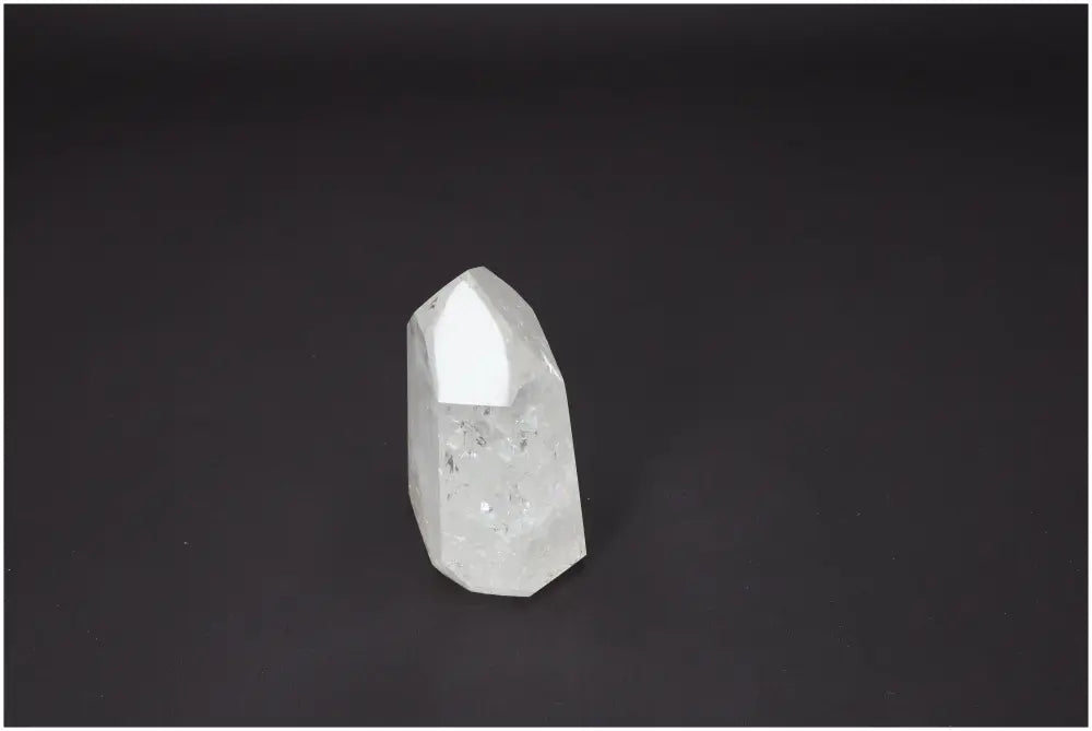 Lemurian quartz obelisk against a dark background, showcasing its unique crystal formations and spiritual properties.