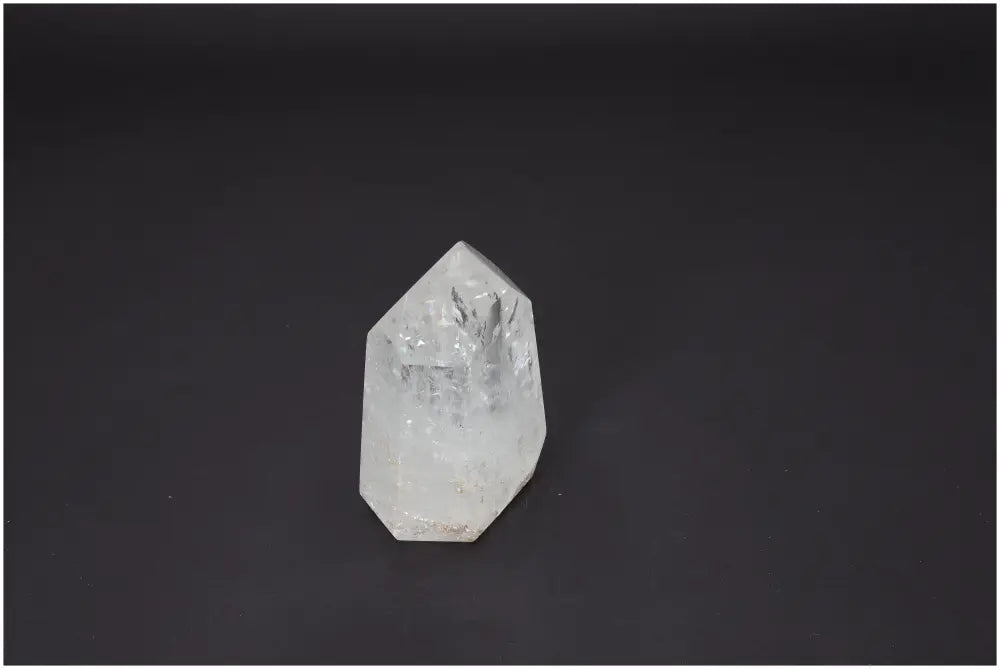Lemurian Quartz Obelisk against black background, showcasing unique crystal properties for chakra balancing and spiritual energy support.