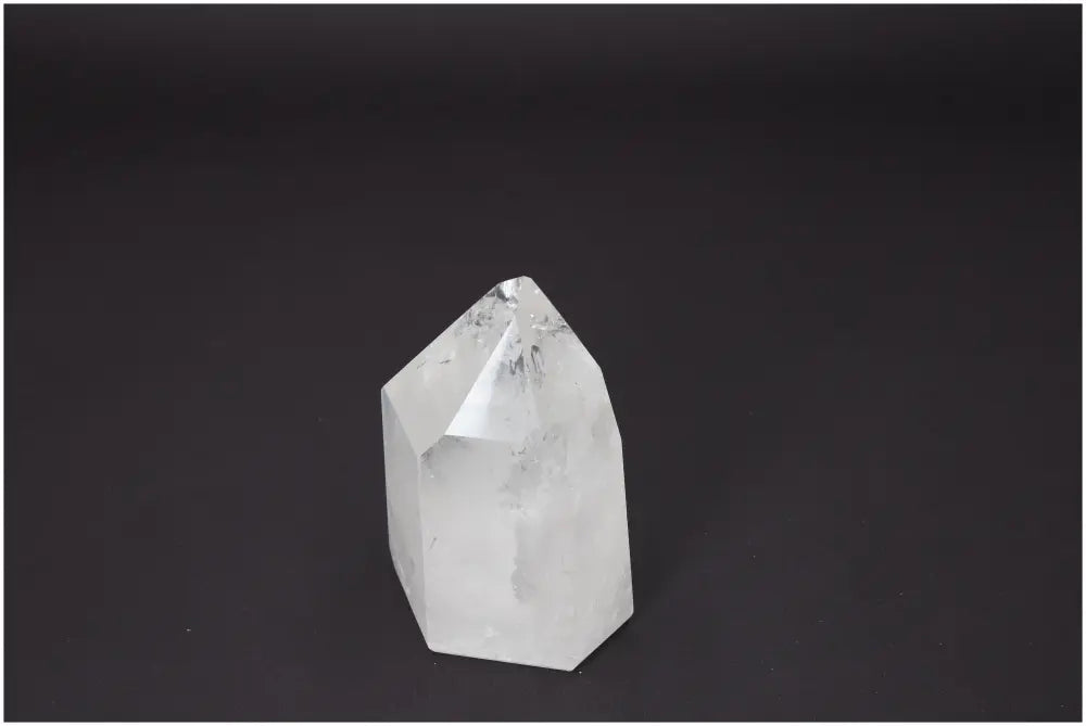 Lemurian Quartz Obelisk on dark background, showcasing unique properties for chakras and zodiac signs spiritual support.