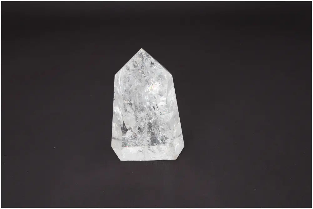 Lemurian Quartz Obelisk on dark background, showcasing clear crystal structure with spiritual and energetic properties for chakras.