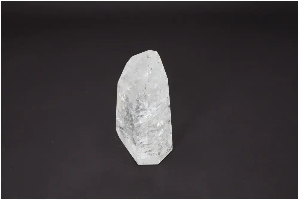 Lemurian Quartz Obelisk on dark background, known for unique chakras, zodiac properties, and spiritual healing energy.