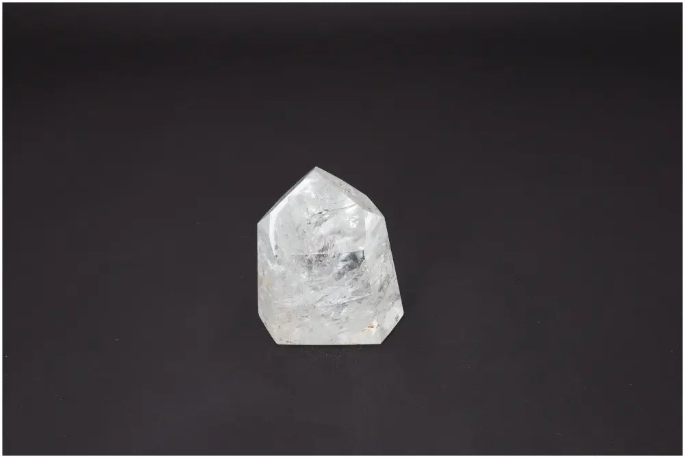 Lemurian Quartz Obelisk against dark background, unique crystal with energetic properties for chakra alignment and spiritual support.