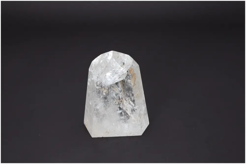 Lemurian Quartz Obelisk against dark background, showcasing its unique color and energetic properties for chakra and zodiac alignment.