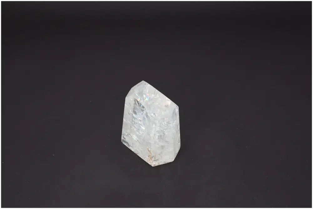 Lemurian Quartz Obelisk against a dark background, showcasing its unique properties and association with chakras and zodiac signs.