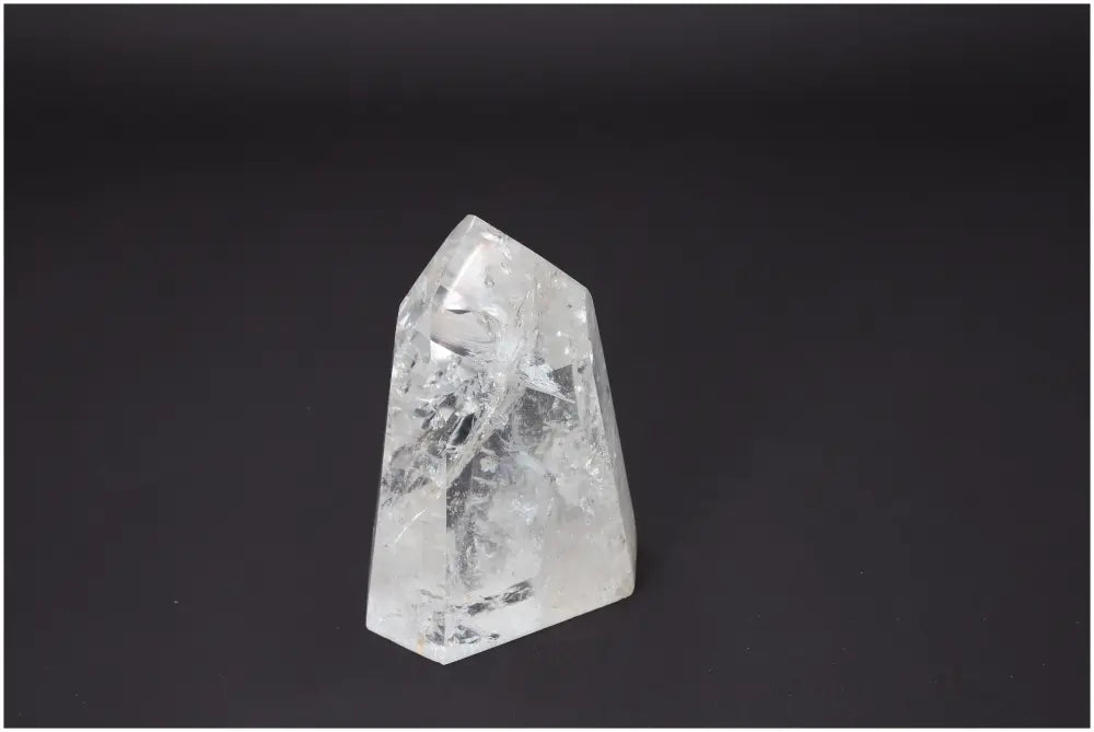 Clear Lemurian Quartz Obelisk on black background showcasing unique crystal formations for chakra and zodiac energy alignment.