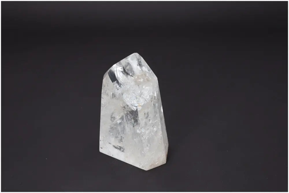 Lemurian Quartz Obelisk with unique properties for energy healing, chakra alignment, and zodiac support on a dark background.