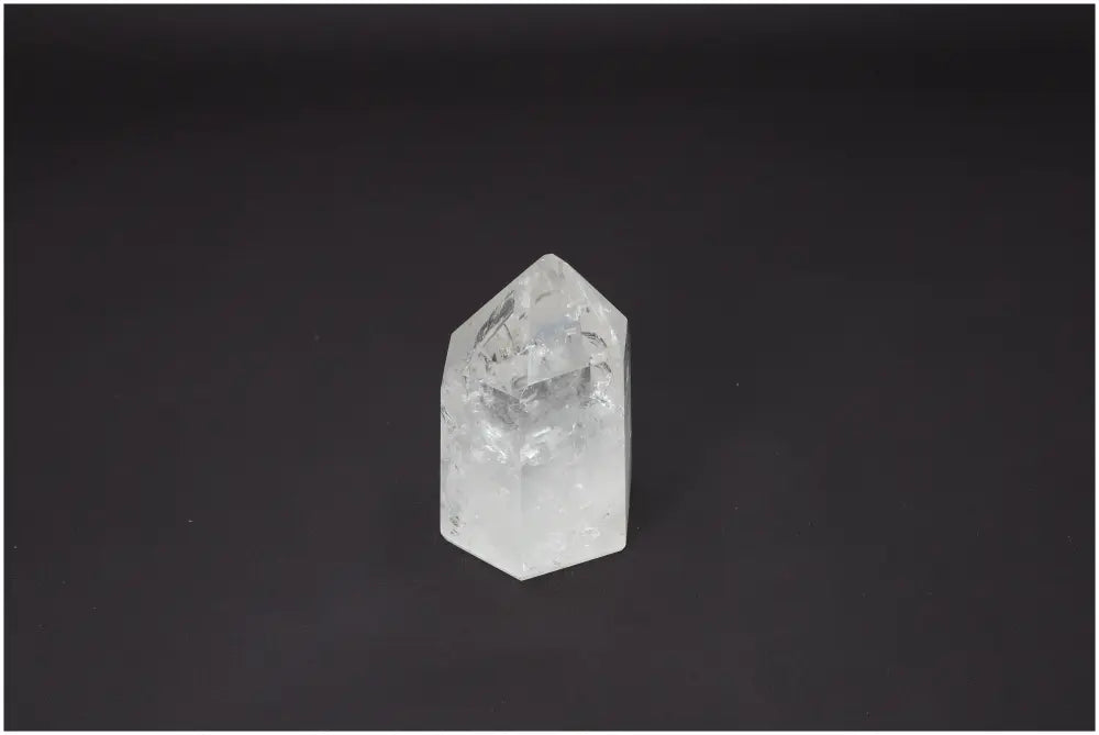 Lemurian Quartz Obelisk on black background, known for energetic and spiritual properties, linked to chakras and zodiac signs.
