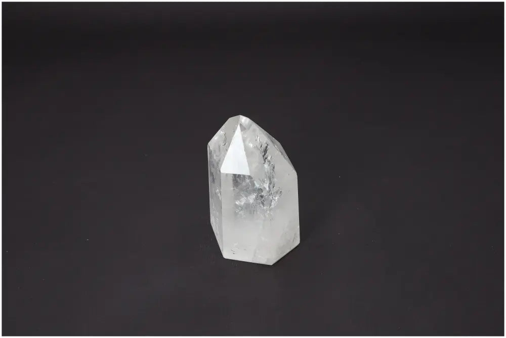 Lemurian Quartz Obelisk crystal on black background, enhances chakra energy, spiritual and zodiac alignment with unique properties.