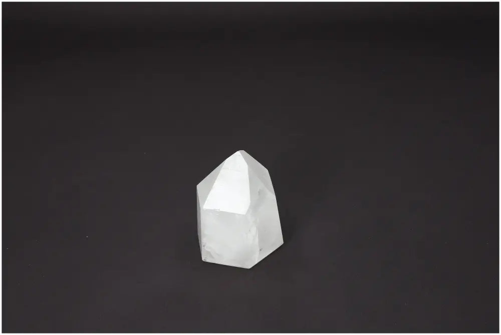 Lemurian Quartz Obelisk crystal on dark background, showcasing its spiritual and healing properties.