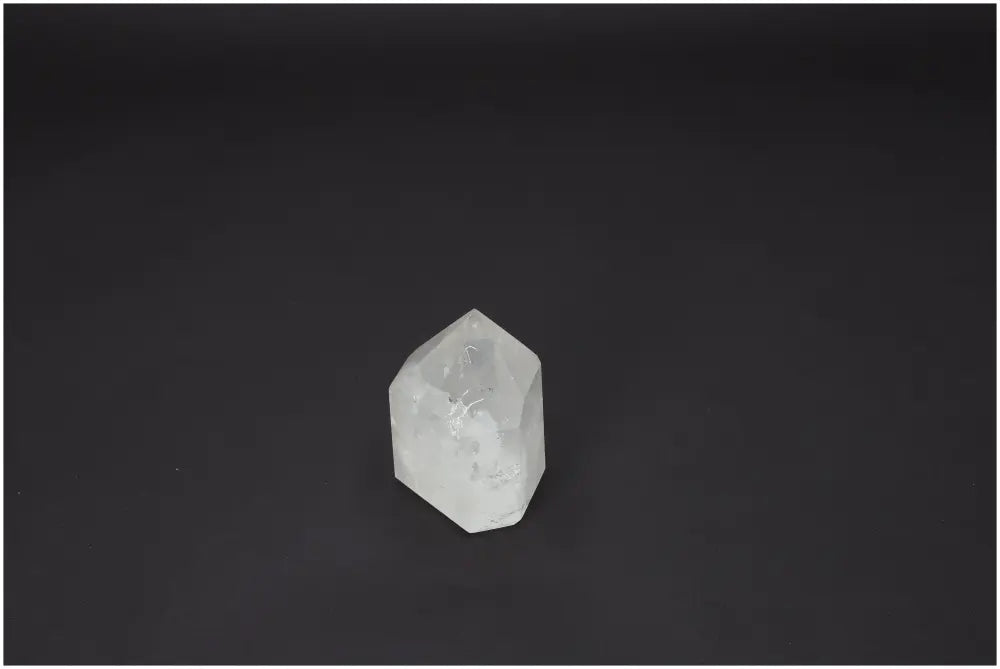 Lemurian Quartz Obelisk on black background, highlighting crystal clarity and spiritual energy properties for chakra and zodiac alignment.