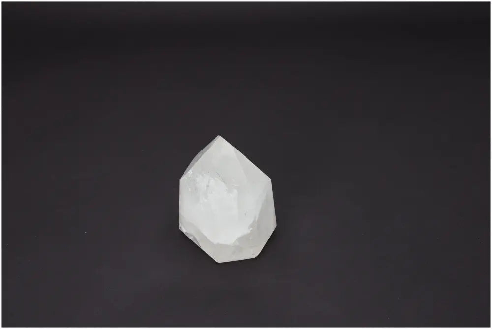 Lemurian Quartz Obelisk crystal against black background, showcasing its unique properties and association with chakras.