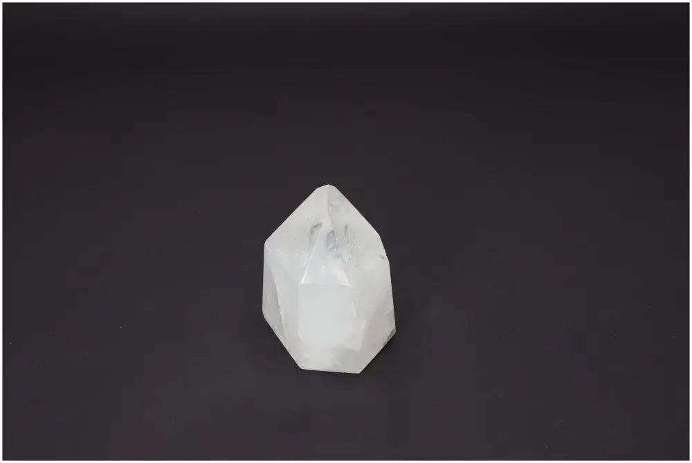 Polished Lemurian Quartz Obelisk on a dark background, ideal for chakra healing and spiritual enhancement.