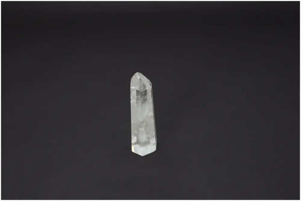 Lemurian Quartz Obelisk for chakra and zodiac energy alignment on dark background