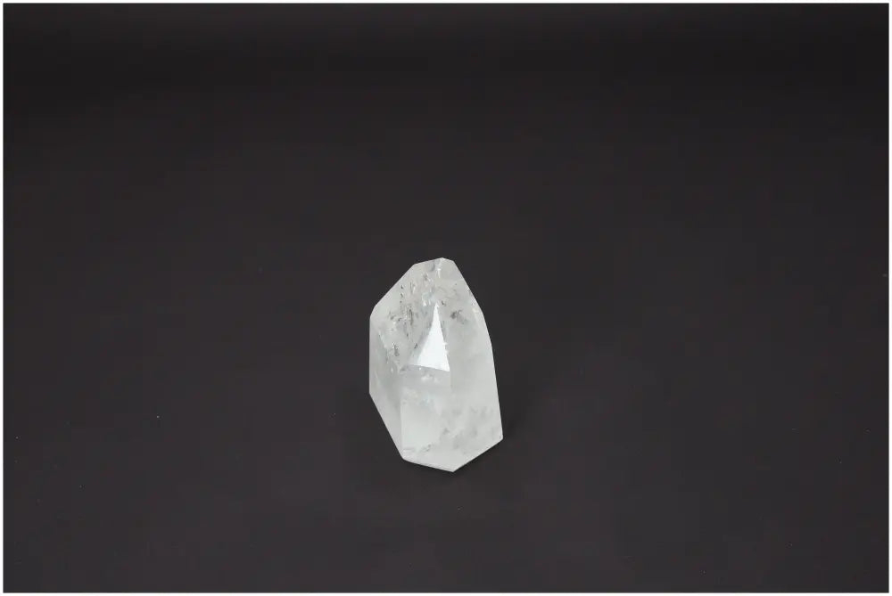 Lemurian Quartz Obelisk against a dark background, showcasing its unique spiritual properties for chakras and zodiac elements support.