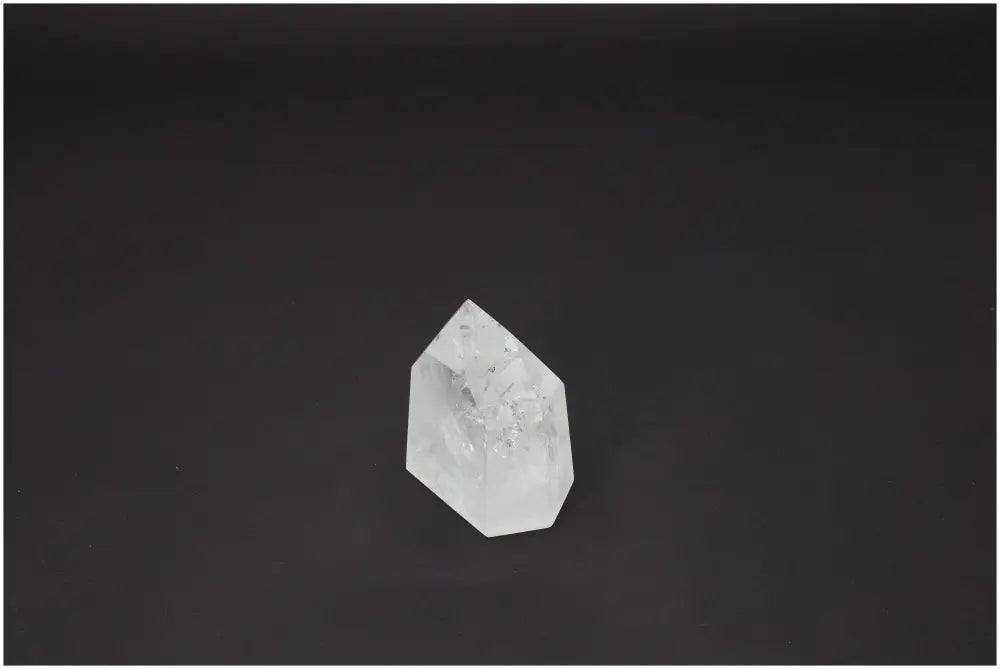 Lemurian Quartz Obelisk on a black background, showcasing spiritual and energetic crystal properties.