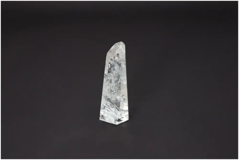 Lemurian Quartz Obelisk with unique energy properties, aligned with chakras and zodiac signs, against a dark background.
