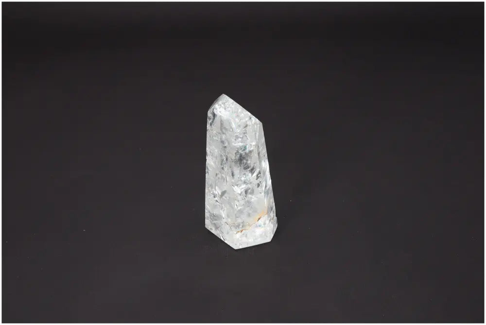Lemurian Quartz Obelisk on black background, showcasing unique energetic and spiritual properties for chakra alignment.