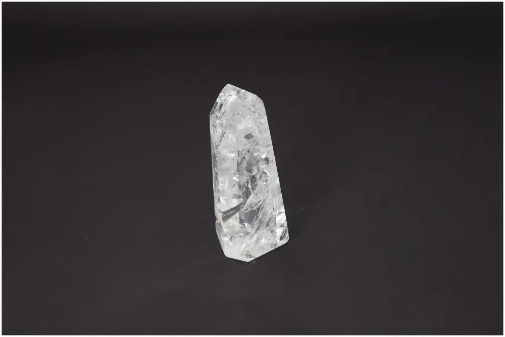 Lemurian Quartz Obelisk on black background, showcasing its unique crystal structure and spiritual energy properties.