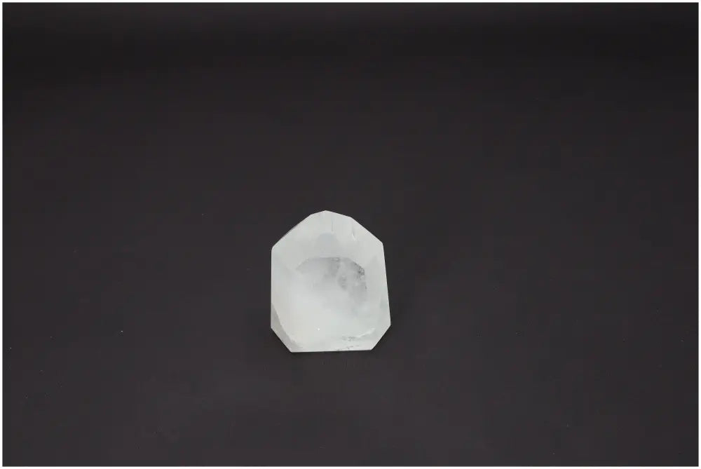 Lemurian Quartz Obelisk on a dark background, showcasing its unique properties and spiritual associations with chakras and zodiac signs.