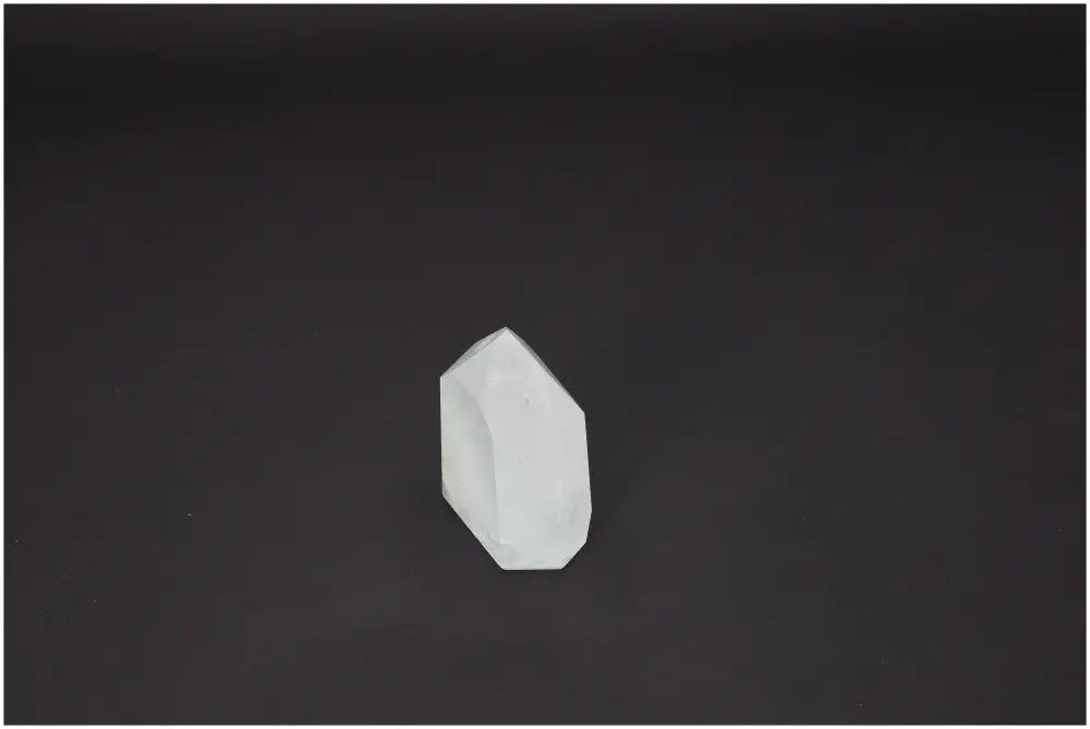 Lemurian Quartz Obelisk on dark background, highlighting its natural energy and spiritual benefits for chakras and zodiac signs.