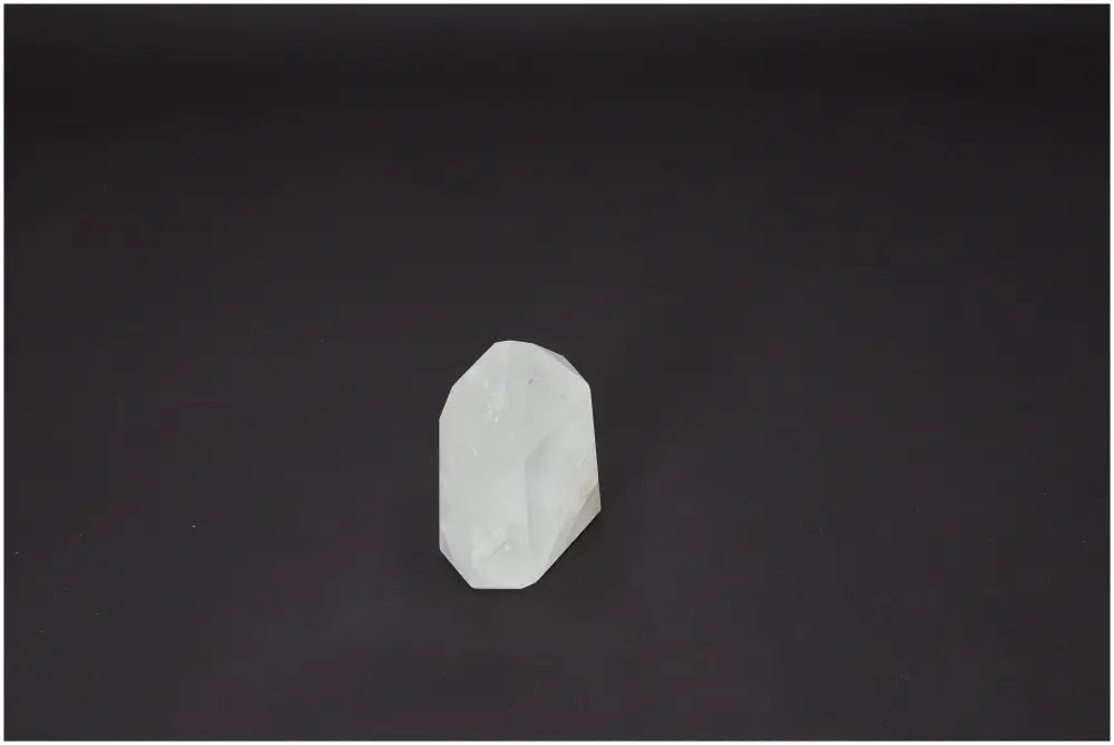 Lemurian Quartz Obelisk on dark background, known for its chakra and zodiac energy properties, balancing body and soul.