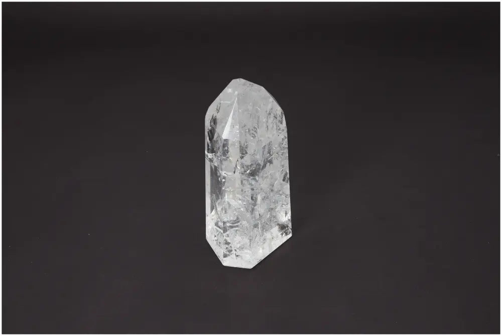 Lemurian Quartz Obelisk on a dark background, showcasing its clarity and unique properties for chakra and zodiac energy alignment.