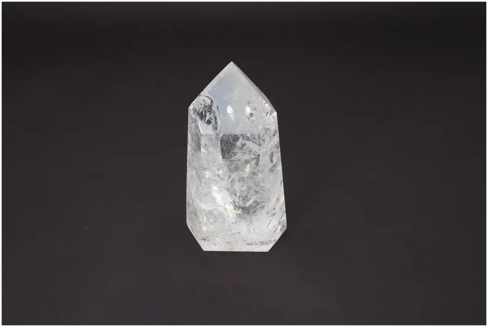 Lemurian Quartz Obelisk crystal for chakra healing and spiritual energy balance on a dark background.