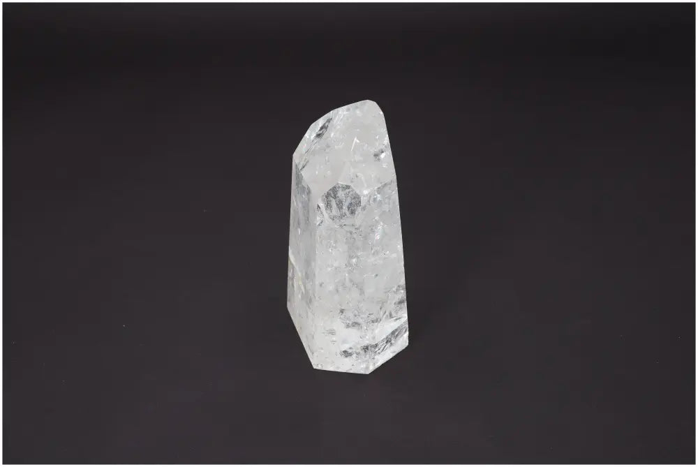 Lemurian Quartz Obelisk crystal against a dark background, showcasing its unique structure and spiritual properties.